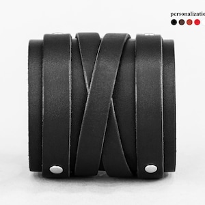 May include: Black leather bracelet with a braided design and silver studs.
