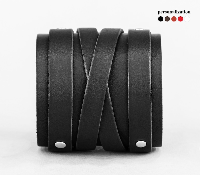 May include: Black leather bracelet with a braided design and silver studs.