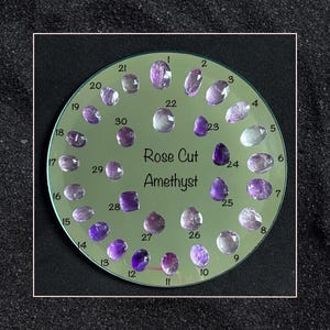 May include: A circular display of 30 rose cut amethyst gemstones, numbered 1 through 30. The display is labeled "Rose Cut Amethyst".