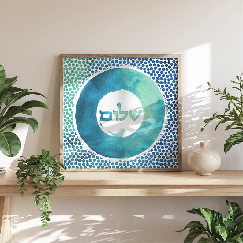 May include: A blue and green watercolour print with a circle design and the Hebrew word "Shalom" in the centre. The background is a pattern of blue dots.