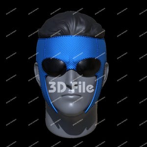 May include: A blue superhero mask with black eye coverings and a textured pattern. The mask is displayed on a mannequin head with black hair. The text "3D File" is visible on the mask.