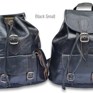 May include: Two black leather backpacks with adjustable straps and buckles. The backpack on the left has a drawstring closure and multiple pockets. The backpack on the right has a flap closure with a buckle. Both backpacks are labeled "Black Small".