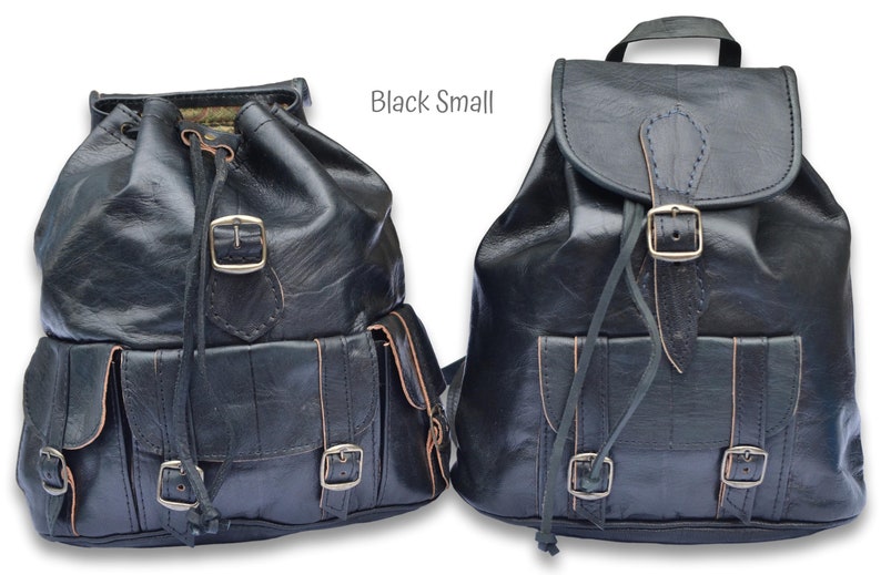 May include: Two black leather backpacks with adjustable straps and buckles. The backpack on the left has a drawstring closure and multiple pockets. The backpack on the right has a flap closure with a buckle. Both backpacks are labeled "Black Small".