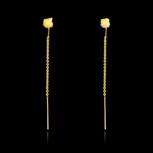 May include: A pair of gold earrings with a small iridescent stone at the top and a long, thin gold chain hanging down.