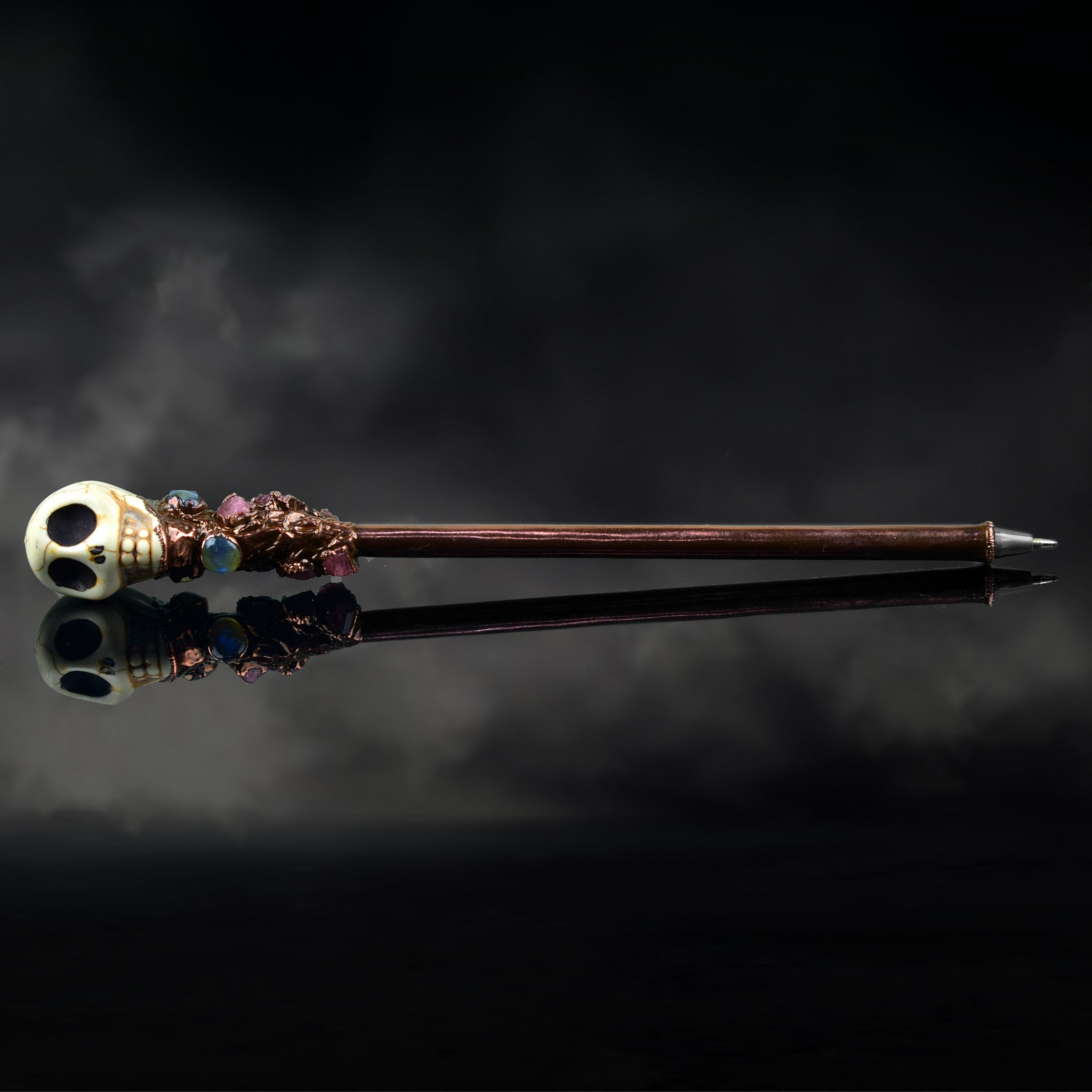 A pen with a skeleton head at the end of it