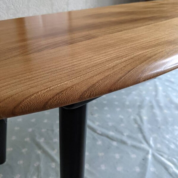 Long Mid Century style coffee table made from solid elm wood, created from a vintage, repurposed Ercol headboard, with matt black legs