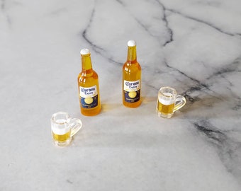 May include: Two miniature glass bottles of Corona Extra beer and a miniature glass beer mug.