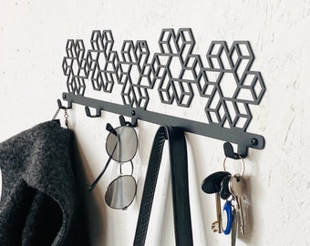 Industrial style steel wall mounted coat & hat rack with design element covered with powder coating