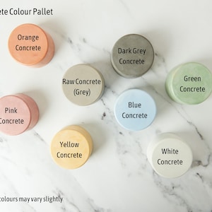 May include: A color pallet of concrete samples in various colors, including orange, pink, dark grey, raw grey, blue, green, yellow, and white. The text "Concrete Colour Pallet" is at the top of the image. The text "*Exact colours may vary slightly" is at the bottom of the image.