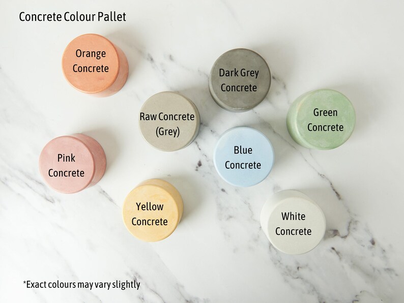 May include: A color pallet of concrete samples in various colors, including orange, pink, dark grey, raw grey, blue, green, yellow, and white. The text "Concrete Colour Pallet" is at the top of the image. The text "*Exact colours may vary slightly" is at the bottom of the image.