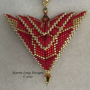 May include: A red and gold beaded pendant in the shape of a triangle with a gold clasp and a black cord. The pendant is made of small beads and has a geometric design. The pendant is labeled "Karen Long Designs © 2017".