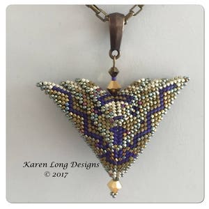 May include: A purple, gold, and white beaded pendant with a geometric design. The pendant is attached to a bronze chain. The pendant is labeled "Karen Long Designs © 2017".