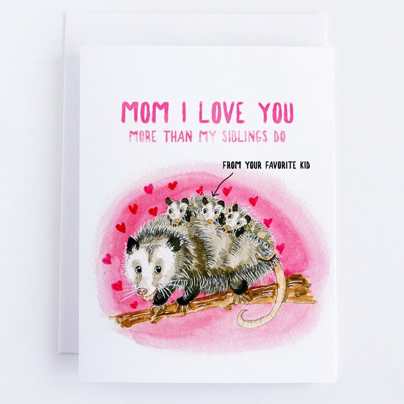 May include: A pink and white card with a watercolor illustration of a mother opossum with her babies. The card reads "Mom I love you more than my siblings do. From your favorite kid."