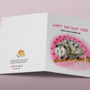 May include: A greeting card with a watercolor illustration of a possum with babies on its back. The card says "Happy Birthday Mom" and "From your favorite kid".