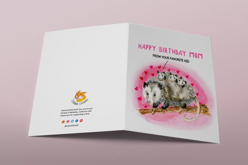 May include: A greeting card with a watercolor illustration of a possum with babies on its back. The card says "Happy Birthday Mom" and "From your favorite kid".
