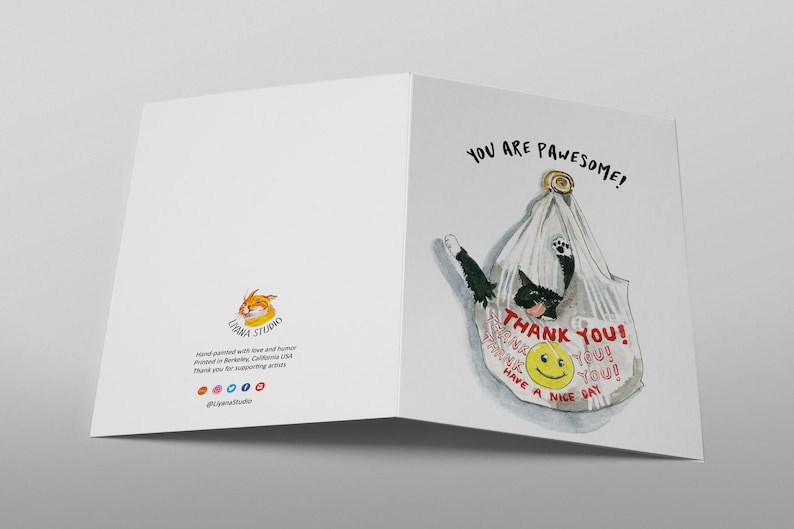 May include: A greeting card with a black cat in a white plastic bag. The bag has red text that says "Thank You!" and a smiley face. The card has the text "You are pawsome!" in black.