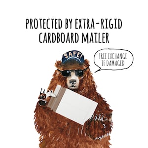 May include: A brown bear wearing a blue hat with the word "SAFE!" on it and sunglasses is holding a cardboard mailer. The mailer is white with a brown border. A speech bubble above the bear says "FREE EXCHANGE IF DAMAGED". The text "PROTECTED BY EXTRA-RIGID CARDBOARD MAILER" is at the top of the image.