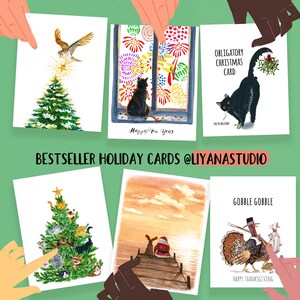 May include: A set of five illustrated holiday cards featuring a variety of themes, including a cat watching fireworks, a cat with mistletoe, a cat-filled Christmas tree, a dog and Santa on a dock, and a turkey with a pilgrim hat. The cards are all watercolor illustrations with a whimsical style.
