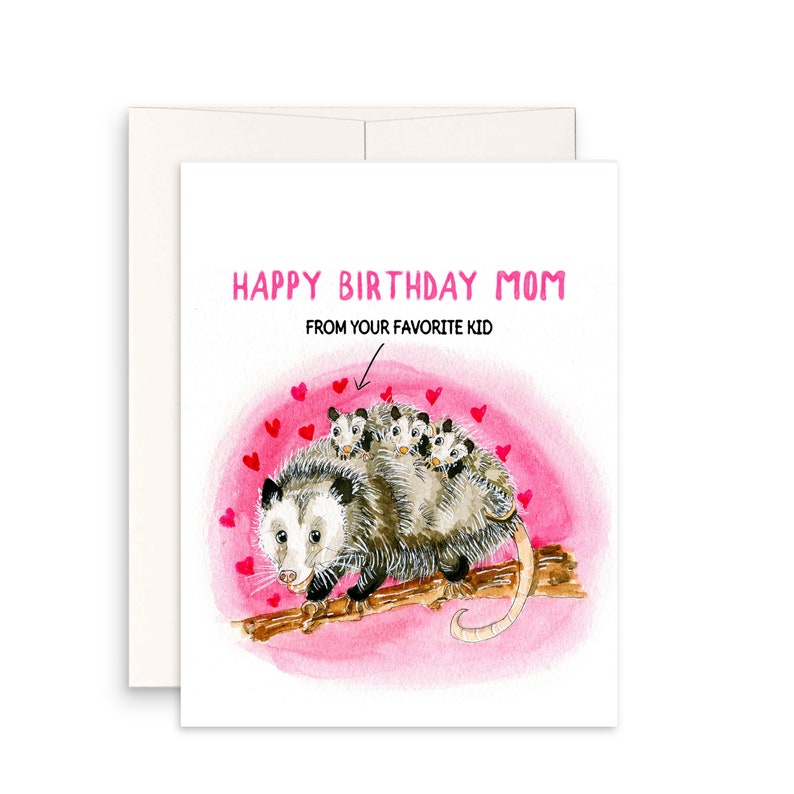 May include: A pink and white birthday card with a watercolor illustration of a possum with babies on its back. The card says "Happy Birthday Mom" and "From your favorite kid".