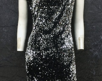 Silver sequined, black velvet dress, with asymmetric folded collar and shoulder detail. Size: Medium UK size 12-14