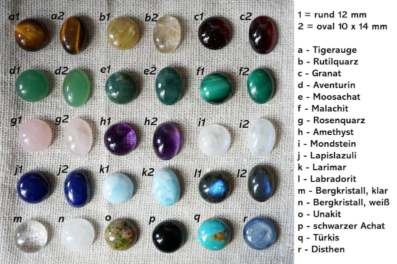 May include: A collection of polished gemstones in various shapes and colors, including tiger's eye, amethyst, and lapis lazuli. The gemstones are round (12 mm) and oval (10 x 14 mm).