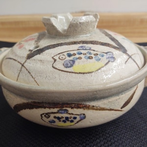 MCM casserole pot; pottery with fish and floral graphics.