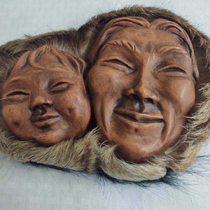 Vintage eskimo parent and child heads; fur trim wall hanging?