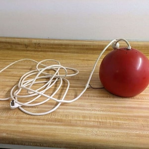 Vtg. MCM semi ball red pullchain rubber cord swag lamp.
