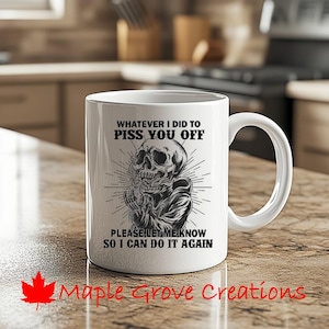 May include: White ceramic coffee mug with a black and white illustration of a skull. The text on the mug reads "Whatever I did to piss you off please let me know so I can do it again."