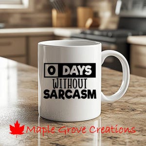 May include: White ceramic coffee mug with a black graphic that reads "0 Days Without Sarcasm".