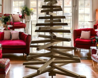 May include: A wooden Christmas tree made of stacked and angled wooden planks. The tree is standing on a wooden base and is in a room with red couches and a rug.