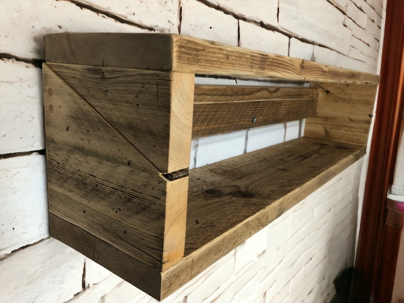 May include: Rustic wooden shelf with a triangular design on the side. The shelf is made of reclaimed wood and has a natural finish.