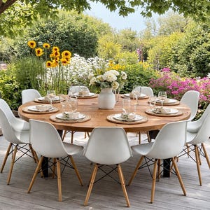 May include: A large round wooden dining table with a natural finish, surrounded by eight white moulded plastic chairs with light wood legs and black metal cross-bracing. The table is set with white plates, glassware, and a central white vase.