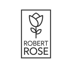 May include: A black and white logo featuring a stylized rose with the text "ROBERT ROSE" in a rectangular frame. The rose is depicted with a simple outline, and the text is in a clean, sans-serif font.