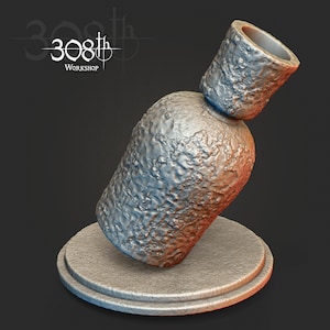 May include: A silver bottle stopper with a textured surface. The stopper is on a round, gray base.