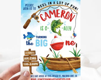 May include: A blue and white fishing themed first birthday party invitation for a boy named Cameron. The invitation features a cartoon fish, a fishing rod, a bobber, and a boat. The text on the invitation reads "Please join us to reel in a lot of fun! Cameron is turning the big one. Saturday, Aug 23rd, 1:00-3:00pm. On's Lake House at 2135 Splash St., Malibu Lake, CA. RSVP: gonefishing@peachpops.com. Copyright Peachpops Parties."