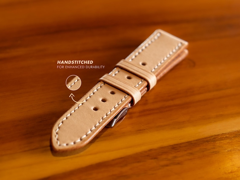 May include: A light brown leather watch strap with white stitching. The strap is handstitched for enhanced durability.