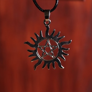 Supernatural Necklace on black cord.  With silver Anti-Possession charm
