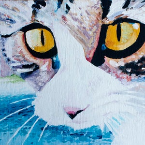 May include: A close-up painting of a cat's face with yellow eyes and white fur. The cat's fur is painted with a textured brushstroke, and the background is a light blue colour.