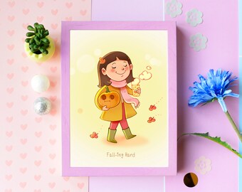 May include: A framed illustration featuring a cartoon girl holding a pumpkin and a beverage, with the text "Falling Hard." The girl wears a yellow coat, pink scarf, and green boots. Autumn leaves and a light yellow background complete the fall theme.