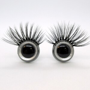 May include: Two large, black plastic eyes with silver rims and long, black eyelashes.