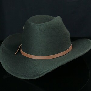 May include: A dark green felt cowboy hat with a brown leather band.