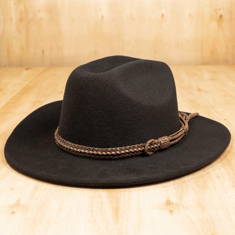 Hand-braided Chèvre goatskin leather hat band displayed on a dark felt hat