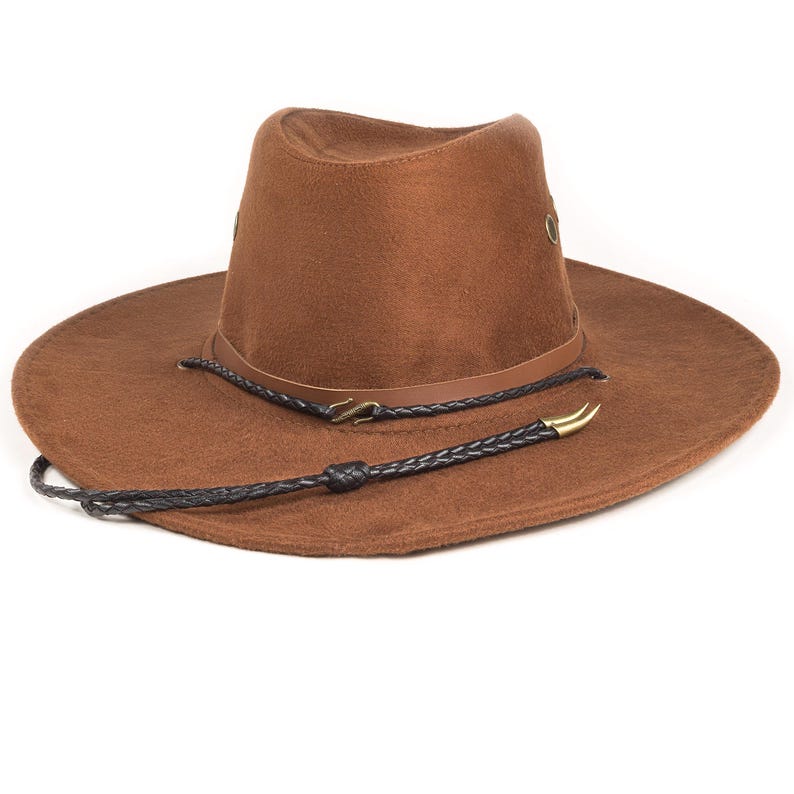 Hand-braided black chèvre leather chin strap with bronze horn tips and hook connectors, shown on a hat with side eyelets