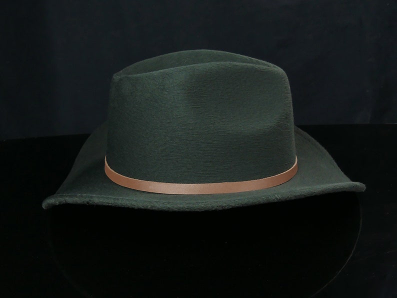 May include: A dark green felt fedora hat with a brown leather band.