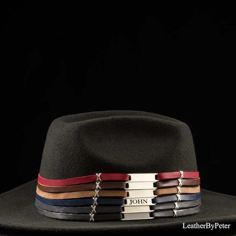 Cowboy hat with personalized leather hat bands and chrome-colored engraved nameplates