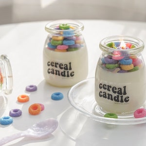 a lit fruit loops cereal candle filled with colorful cereal wax melts, cinnamon sticks, white and orange pumpkins, Ikea mini wood cutting board