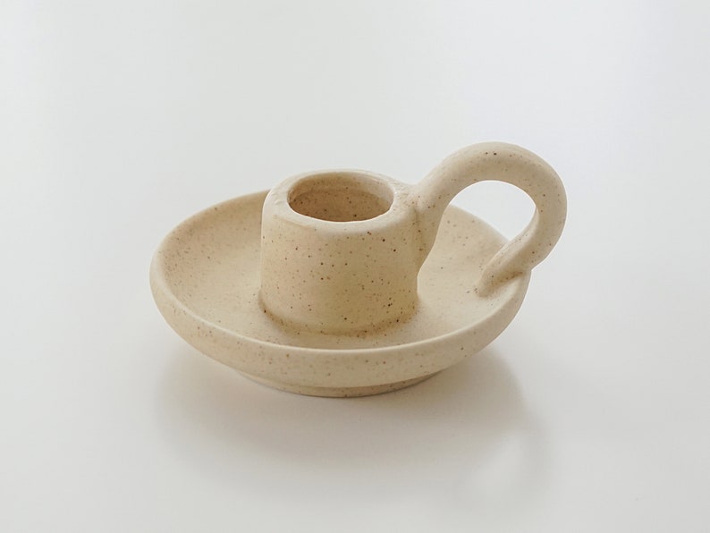 Simple beige color small ceramic candle holder for soy was a candlestick taper made by bluewine studio.