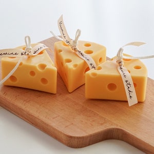 three yellow cheddar cheese soy pillar candles on ikea mini wood board