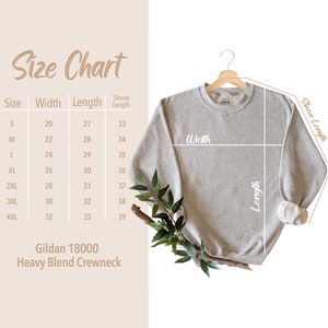 May include: Size chart for a Gildan 18000 Heavy Blend Crewneck sweatshirt. The chart shows the size, width in inches, length in inches, and sleeve length in inches.